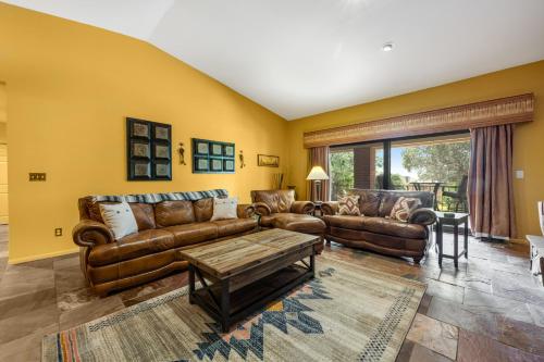 a living room with leather couches and a table at Four Queens in Chapel in Sedona