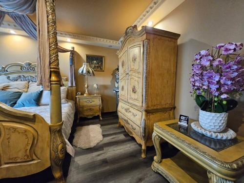 a bedroom with a bed and a dresser with purple flowers at Royal View Apartment in Liepāja