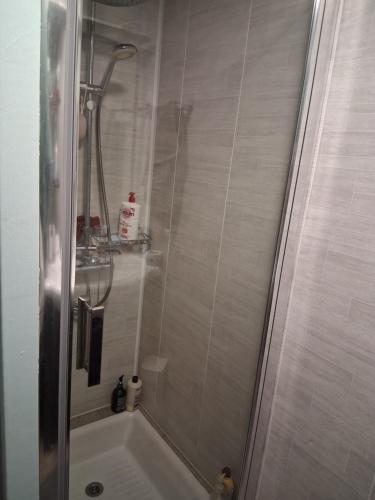 a bathroom with a shower and a bath tub at Maison proche bassin et océan in Arès