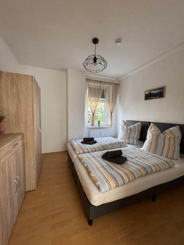 a large bed in a bedroom with a window at ErzNest in Thum