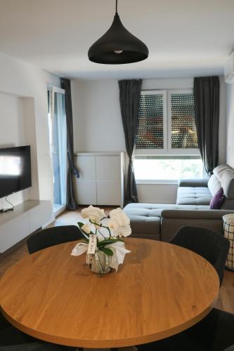 a living room with a table and a couch at MODERN ESCAPE apartment with garage in Split