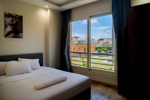 a bedroom with a bed and a large window at 407. Spacious 3BR Apt. 2 Baths Gated Community in Sheikh Zayed