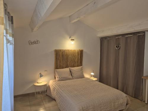 a bedroom with a bed and two lamps on tables at Clos de Valamade in Cannes-et-Clairan