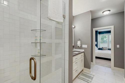 a bathroom with a shower with a glass door at Wander Bentonville in Bentonville