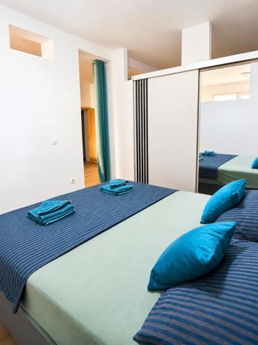 a bedroom with two blue pillows on a bed at Casa Mia in Višići