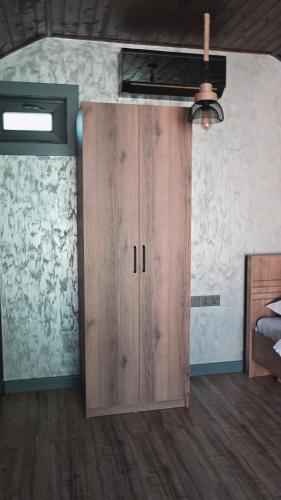 a wooden cabinet in a room with a ceiling at Arcadia Family Vacation House in Çilǝgir
