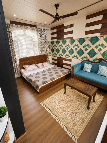 a living room with a bed and a couch at Sultan Homestay in Srinagar