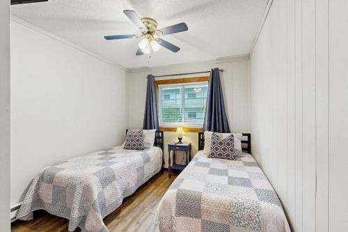 a bedroom with two beds and a ceiling fan at Pinnacle 2101 in Beech Mountain