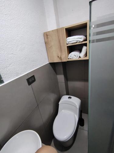 a small bathroom with a toilet and a sink at Departamento Grupo in Lima