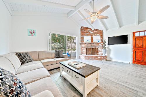a living room with a couch and a fireplace at Balboa Duplex in Newport Beach