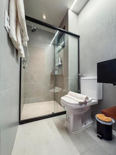 a bathroom with a glass shower and a toilet at NAAY - Nature 106 in Pôrto de Pedras