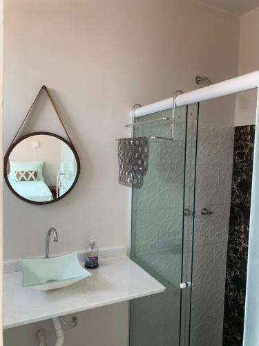 a bathroom with a shower and a sink and a mirror at Guesthouse Villa Dourada in Rio de Janeiro