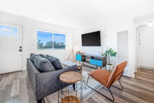 a living room with a couch and a tv at Aloha-Howdy Surf Gateway in San Clemente