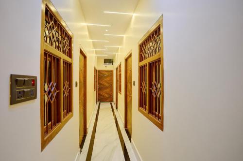 a hallway with wooden doors at Hotel O SINGH GRAND HOTEL& BANQUET in Gorakhpur