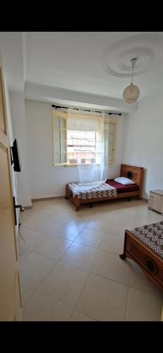 a large room with a bed and a window at اولاد بونار in Jijel