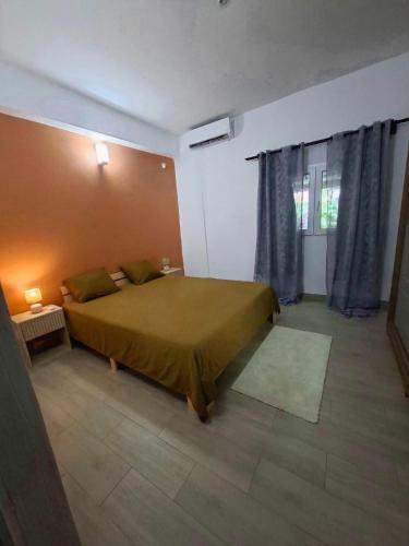 a bedroom with a large bed and a window at Amana in Bandraboua