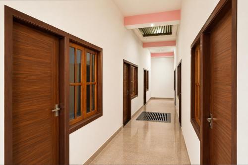 a hallway with wooden doors and a hallway sidx sidx sidx at SPOT ON ROYAL KING HOTEL in Lucknow