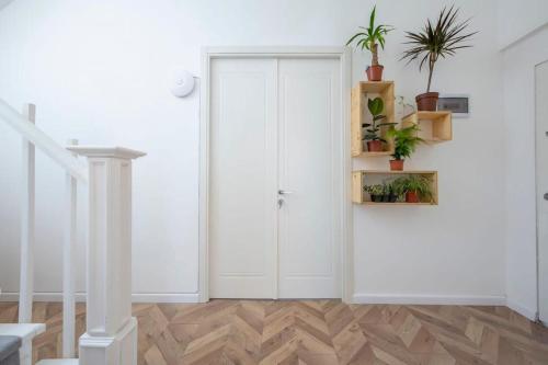 a room with a white door with potted plants at Opera City Center Hotel in Tbilisi City