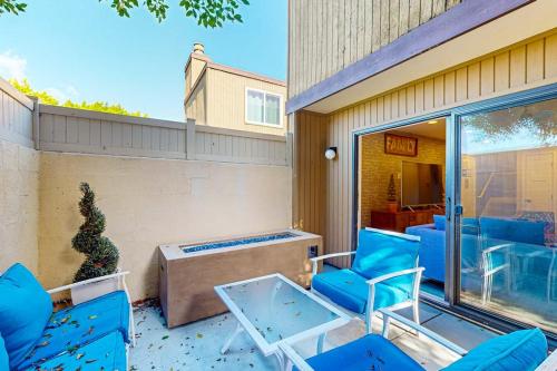 a patio with blue chairs and a table at Castles Reach in Anaheim