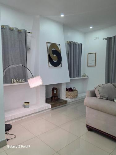 a living room with a couch and a fireplace at 32 on Magasa in Blantyre