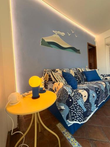 a room with a bed and a table with a table at Casa vacanze SALSEDINE in Mascali