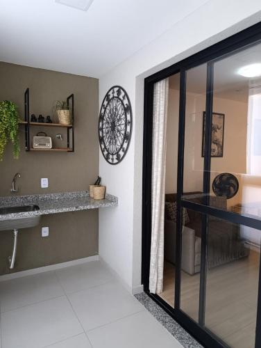 a bathroom with a sink and a mirror at nityloft com piscina e academia em Icaraí in Niterói