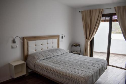 a bedroom with a bed and a window at Casa El Nido, Agaete in Agaete