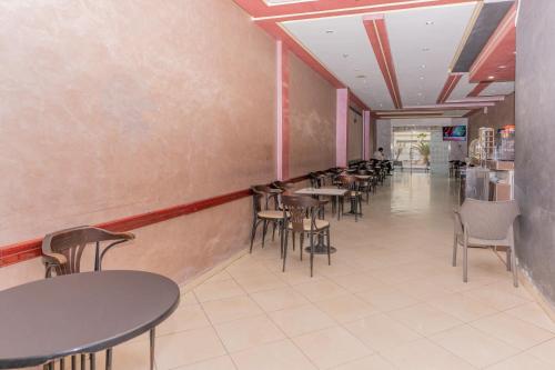 a row of tables and chairs in a restaurant at Erraha Hostel Dakhla in Dakhla