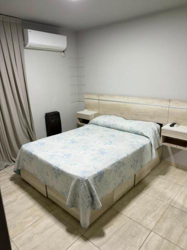 a bedroom with a bed and two night stands at Olivia apart in Chajarí