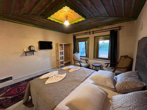 a bedroom with two beds in a room with a ceiling at Falcon Cave Suites in Göreme