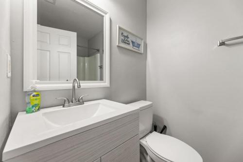 a white bathroom with a sink and a toilet at A Peaceful stay at The Pine Grove Retreat in Ladson