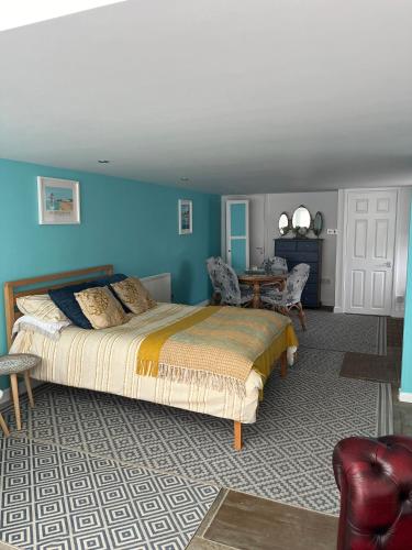 a bedroom with a bed and a table in it at Margate Summerhouse in Westgate-on-Sea