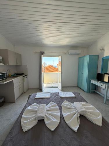 a kitchen with a large bed with bows on it at Blue Street Apartments in Pythagoreio