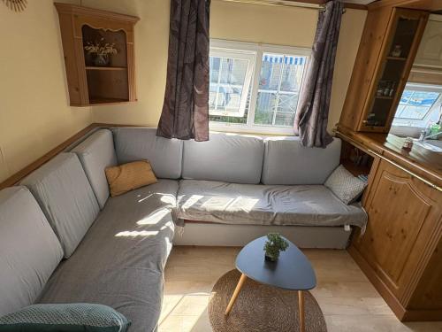a living room with a couch and a table at Mobil home in Ambon
