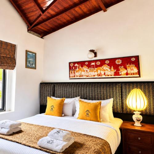 a bedroom with two beds with yellow pillows at Villa Lunka in Nuwara Eliya