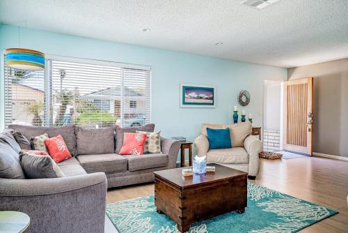 a living room with two couches and a coffee table at Morro Beach Bungalow in Morro Bay