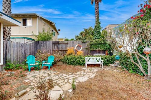a backyard with two chairs and a fence at Sailaway Cabin A in Ventura