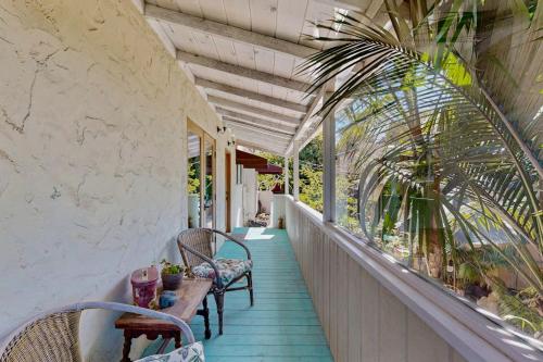a porch with two chairs and a table on it at Urban Ventura Oasis in Ventura