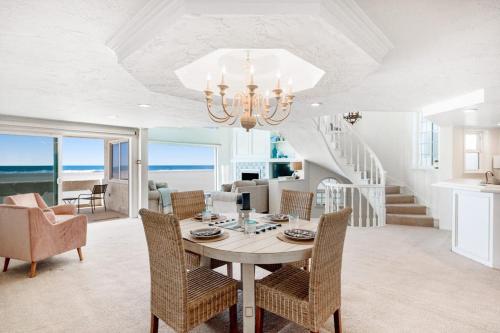 a dining room with a table and chairs at Sandcastle by the Sea in Oxnard
