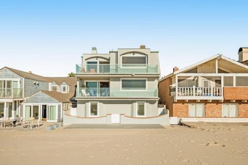 a large house on the beach next to some buildings at Savor the View in Oxnard