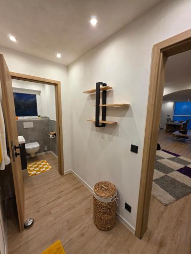 a bathroom with a toilet and a shelf on the wall at Ferienwohnung Sonneninsel in Rednitzhembach
