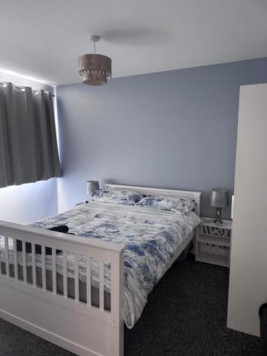 a bedroom with a white bed and a window at Hawksbill way in Peterborough