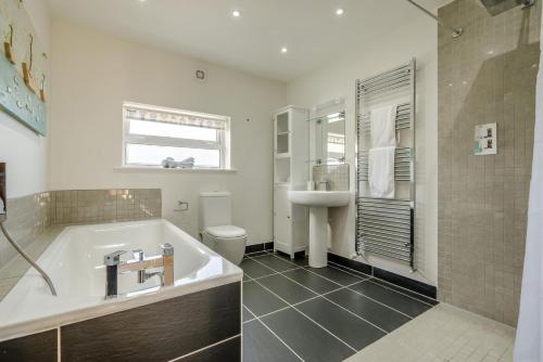 a bathroom with a tub and a sink at 3 Bed in Tintagel oc-a36172 in Tintagel