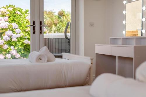 a white room with a window and a bed with towels at 3 Bed in Tintagel oc-a36172 in Tintagel