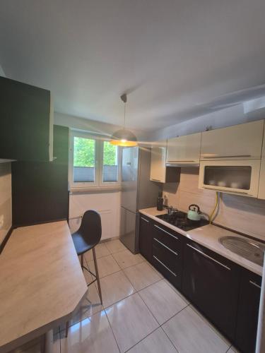 a kitchen with a table and a chair in it at Apartament przy Dworcu Sanok in Sanok