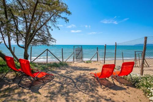 three chairs and a volleyball net on the beach at Casa Giannellina - Happy Rentals in Orbetello