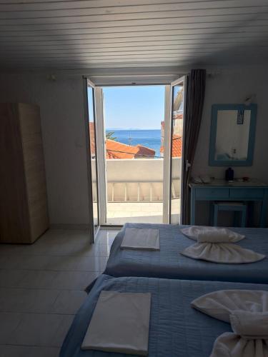 a bedroom with a bed and a view of the ocean at Blue Street Apartments in Pythagoreio