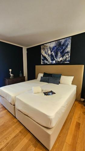 a large white bed in a bedroom with black walls at LÚA Cies Room in Oya