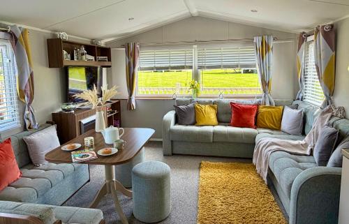 a living room with a couch and a table at Rosie's Seton Retreat in Port Seton