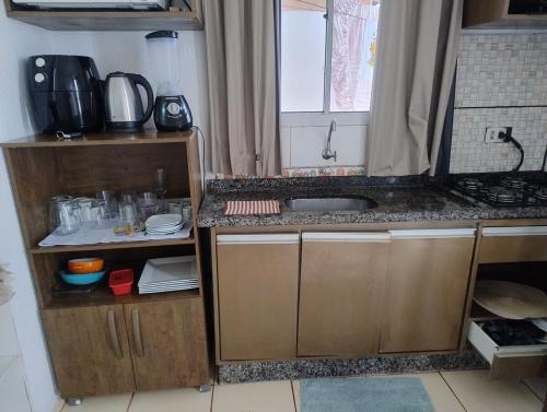 a small kitchen with a sink and a counter at Pedacinho do céu 2 in Dourados